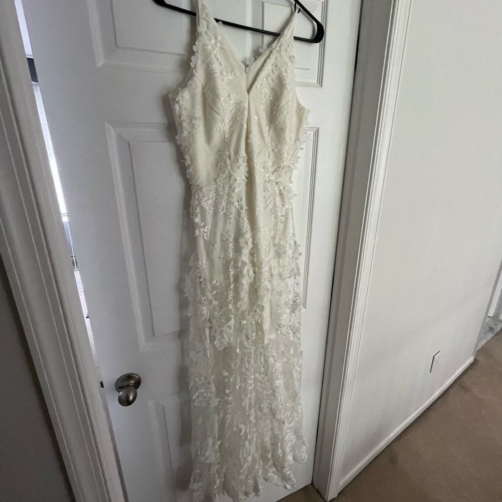 White maxi dress with floral appliqué